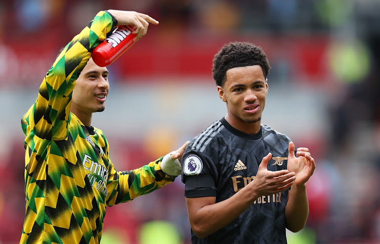 Ethan Nwaneri (right) of Arsenal applauds the fans next to Gabriel Martinelli following the Premier League match against Brentford at Brentford Community Stadium on September 18 2022.