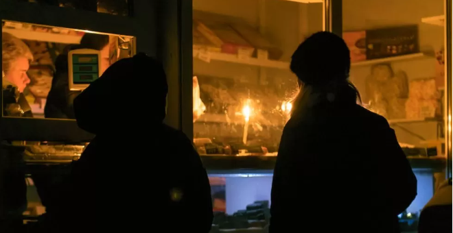 Stores operated by candlelight in a town near Kyiv after strikes hit energy infrastructure