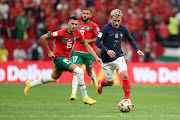 Antoine Griezmann of France controls the ball against Selim Amallah of Morocco in the World Cup semifinal at Al Bayt Stadium on December 14 2022. 