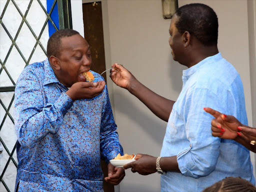 Raila Odinga shares a piece of cake with President Uhuru Kenyatta in Mombasa on January during Raila's birthday.