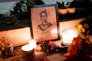 Candles are lit next an illustration of Associate Justice Ruth Bader Ginsburg as people mourn her death at the Supreme Court in Washington, U.S., September 19, 2020.      