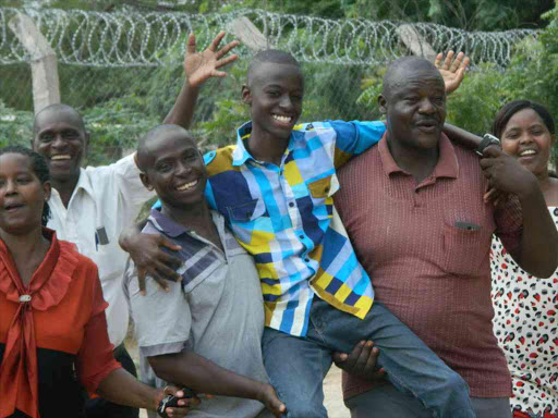 Joseph Gicharu,14 from Garissa Academy is congragulated by his parents and teachers .he got 430 marks emrging the best in northeastern region.