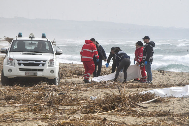 Rescuers recover a body in Cutro, on the eastern coast of Italy's Calabria region, February 26 2023. Picture: GIUSEPPI PIPITA/REUTERS