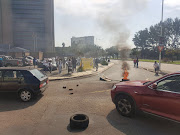 SAPS 10111 call centre workers burnt tyres as part of proteste action in Durban on Friday.