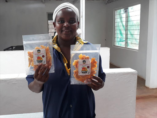Mercy Mwende, founder of Sweet ‘N Dried Enterprises, a value addition company in Tharaka Nithi County displays a sample of ready to eat dried mangoes.