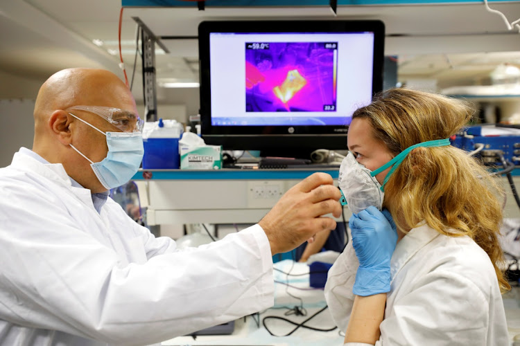 Israeli Professor Yair Ein-Eli, who led the research team which say they have invented a reusable face mask that can disinfect itself and kill the coronavirus disease (COVID-19), takes part in a demonstration for Reuters at a laboratory in Haifa, northern Israel.