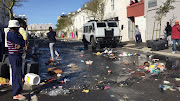 Police clash with protesters who are resisting eviction in Cape Town. 