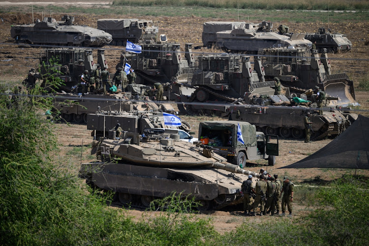 Israeli heavy armour and tanks are seen in a staging area near Sderot, Israel. Picture: LEON NEAL