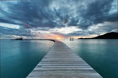 A pier in tranquil Martinique at sunset. 