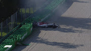 Kimi Raikkonen goes into the barriers at the Parabolica.