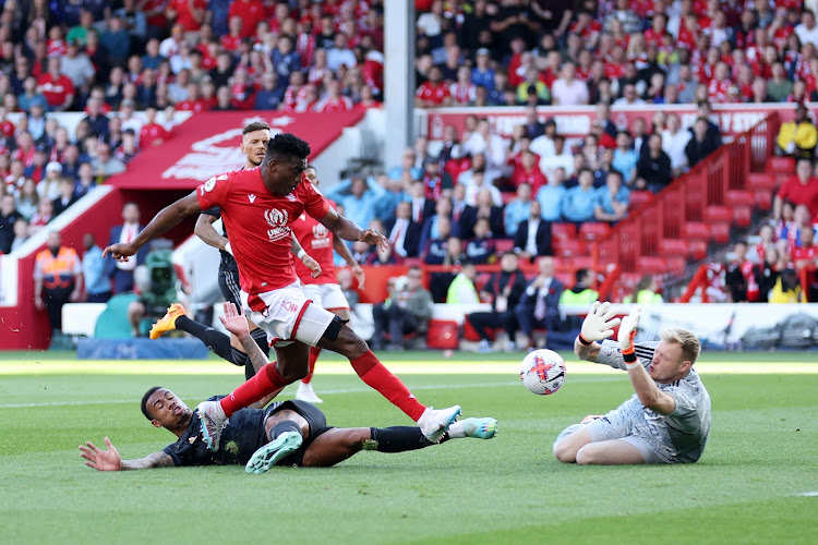 Taiwo Awoniyi of Nottingham Forest scores the team's first goal past Aaron Ramsdale of Arsenal in the Premier League match at the City Ground in Nottingham on May 20, 2023.