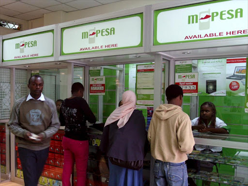 Customers queue outside an M-Pesa shop in Nairobi