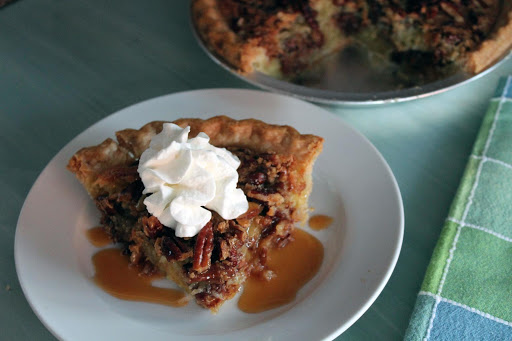 A slice of german chocolate vinegar pie with a dollop of whipped cream