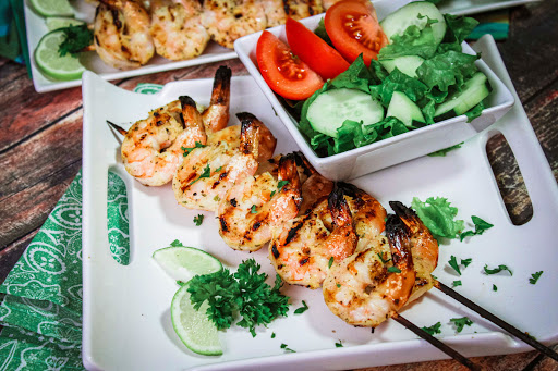 Skewers of Honey Mustard Shrimp on a plate.