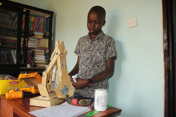 Ethan Simiyu,14, explaining how the Hydraulic arm he invented works.