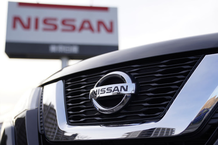 The Nissan logo is seen on the grille of an X-Trail sports utility vehicle (SUV) displayed outside a Nissan dealership.