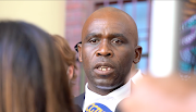 Luvuyo Godla, lawyer for arson accused Zandile Christmas Mafe, addresses the media outside the Cape Town magistrate's court on January 4. 