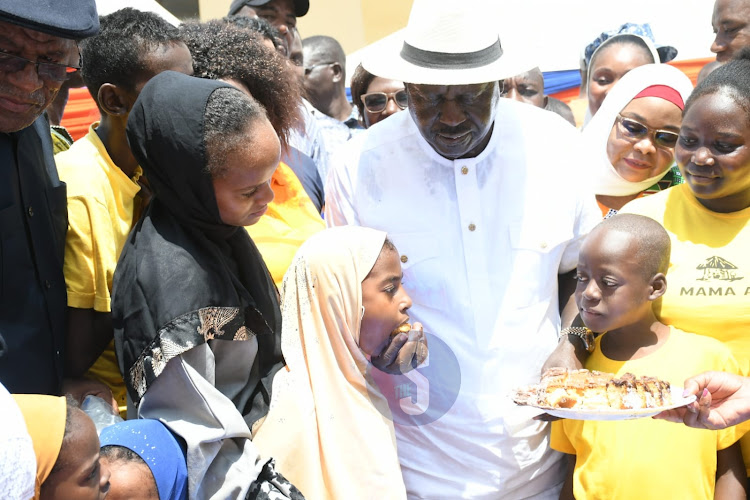 Azimio Leader Raila Odinga sharing cake with kids during celebrations of his 79th birthday in Malindi on Saturday, December 7, 2024.