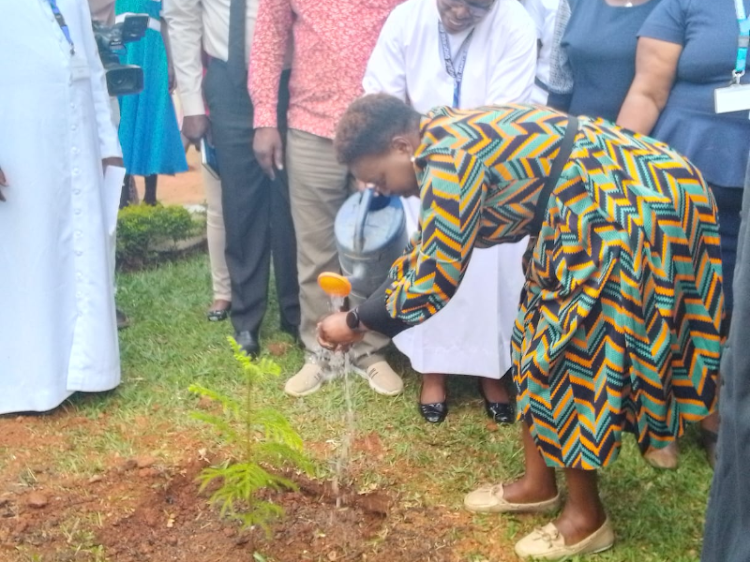 Health CS Susan Nakhumicha watering a tree at St. Mary's Mission Hospital in Kakamega County.