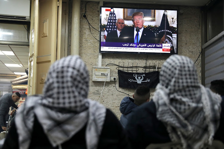 Palestinians watch a televised broadcast of US President Donald Trump delivering an address to announce that the United States recognises Jerusalem as the capital of Israel, in Jerusalem's Old City December 6, 2017.