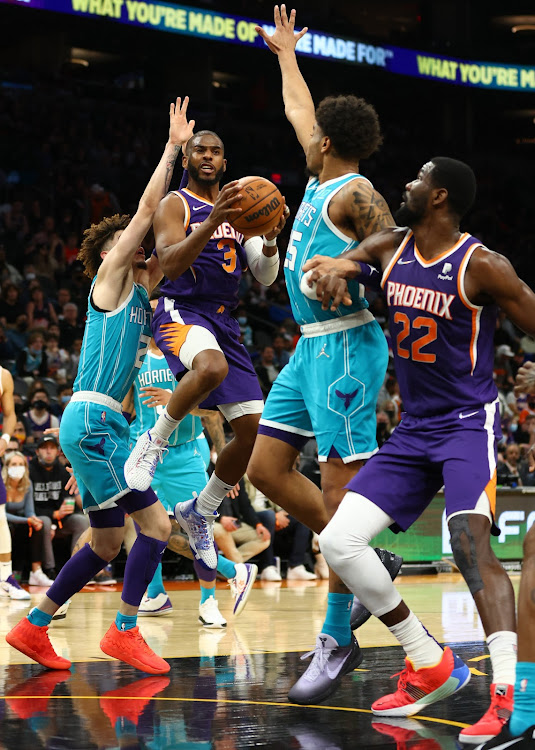 Phoenix Suns guard Chris Paul (3) moves the ball against the Charlotte Hornets in the first half at Footprint Center.