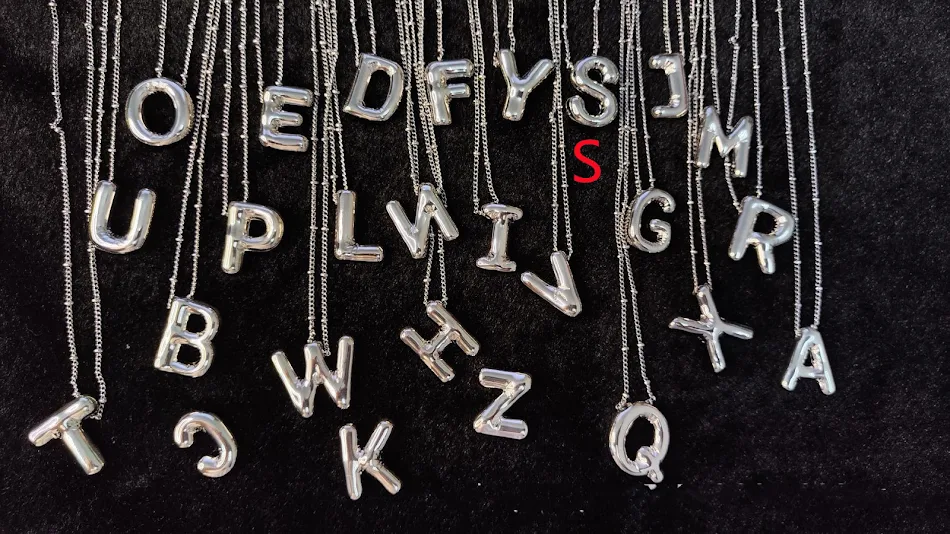 Collier avec pendentif lettres brillantes en cuivre. Ajoutez une touche élégante et personnalisée à votre look. Un accessoire parfait.