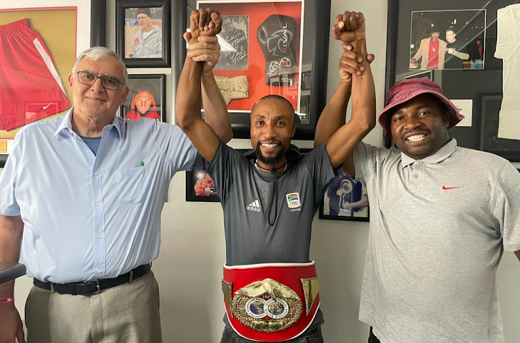 Bongani Mahlangu poses with his IBF Africa junior-featherweight title alongside IBF Africa representative Andre de Vries, left, and his coach/manager, brother Sandile.