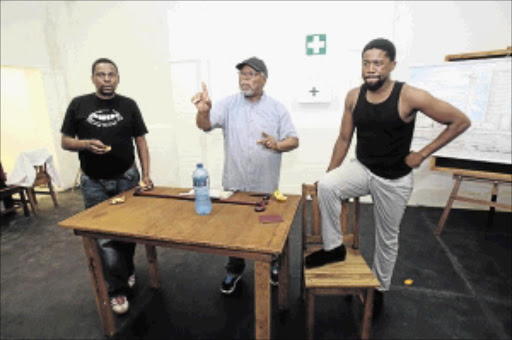 historic moment: Director John Kani gives notes to actors Mncendisi Shabangu and Atandwa Kani during rehearsals for 'Sizwe Banzi is Dead', starting next week at the Market Theatre in Newtown PHOTO: Veli Nhlapo