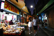 People shop at a market as the spread of the coronavirus disease (Covid-19) continues in Taipei. 