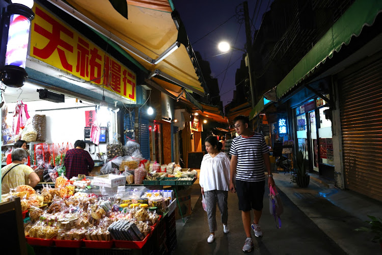 People shop at a market as the spread of the coronavirus disease (Covid-19) continues in Taipei.