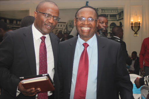 Family bank Managing director Peter Munyiri with the group Chairman Wilfred KIboro at the investors briefing in Nairobi on March 24. Photo/Enos Teche.