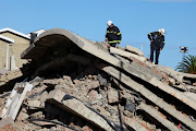 Rescuers search for construction workers trapped under a building that collapsed in George.