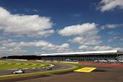 Valtteri Bottas of Finland driving the (77) Williams Martini Racing Williams FW38 Mercedes PU106C Hybrid turbo on track ahead of Lewis Hamilton of Great Britain driving the (44) Mercedes AMG Petronas F1 Team Mercedes F1 WO7 Mercedes PU106C Hybrid turbo during practice for the Formula One Grand Prix of Great Britain at Silverstone on July 8, 2016 in Northampton, England. 