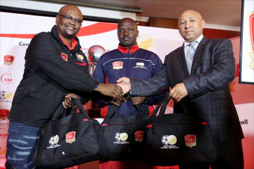 GRAND GESTURE: SA Breweries' corporate affairs specialist Tinomzi Lubelwano, left, with BCM regional team coach Themba Smanga, centre, and Safa-BCM president Prince Sibam during the official handover of the technical kit at the SAB Depot in East London Picture: SIBONGILE NGALWA