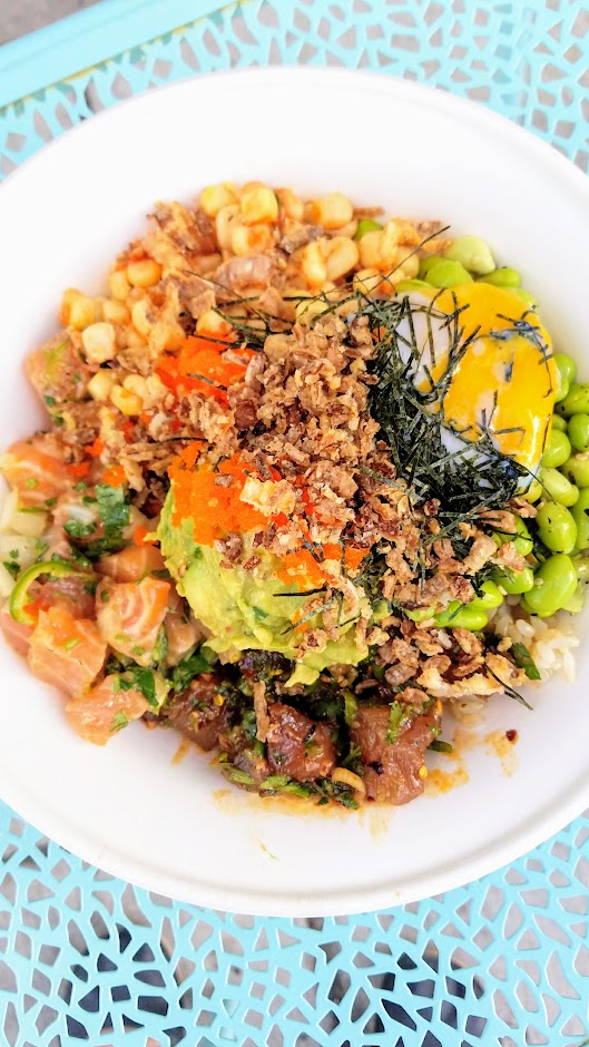 SeaSweets Poke - customize your own poke bowl with among half a dozen poke options and a lot of creative toppings over rice or greens. When the temperatures are up nothing is so satisfying as a poke bowl with all your favorite custom fixings over white or brown rice or kale salad to nourish and cool you off. Here I stacked it with Salmon in house ponzu and Albacore in house fried chili oil and black vinegar shoyu, Kimchee Corn, Hijiki Edamame, Sambal Guacamole, fried onion, furikake, and extra richness with a Sous-Vide Runny Egg from Sea Sweets Poke 