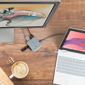 An overhead view of a Chromebook with a USB cable inserted into an open port.