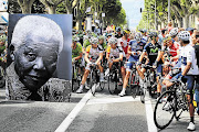 The peloton waits behind a large picture commemorating the birthday of former South African president Nelson Mandela before yesterday's 18th stage of the race