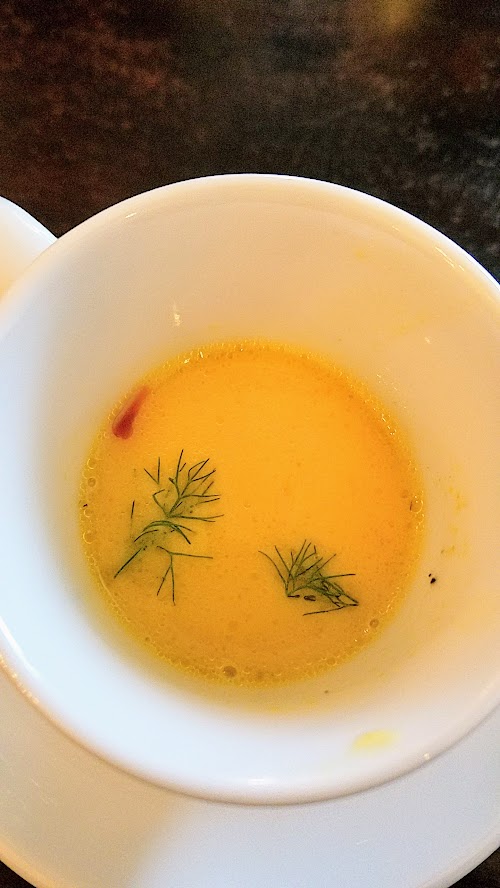 Verdigris amuse bouche of a saffron bouillabaisse