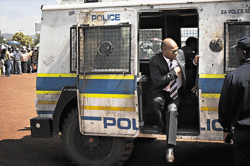 Police Minister Nathi Mthethwa leaving a police Nyala to speak to the people of Ratanda, south of Heidelberg, yesterday