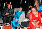 Former justice minister Jeff Radebe, Winnie Madikizela-Mandela and birthday girl Zindzi Mandela view a slide show of family pictures at her 50th birthday party  at Randlords nightclub in Braamfontein on January 15 2011.