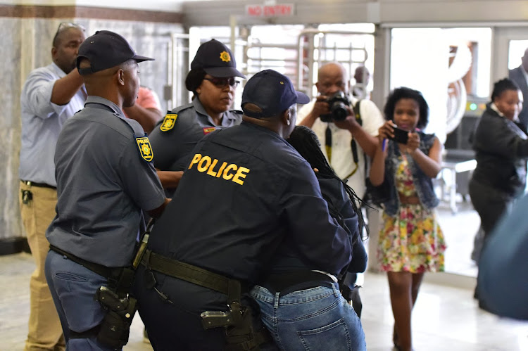 One of controversial Nigerian pastor Timothy Omotoso's supporters being dragged out of the Port Elizabeth court for misinformation on October 9 2018