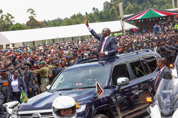 President William Ruto waving at Kericho residents as he leaves Kericho Green Stadium after the Mashujaa celebrations on October 20, 2023