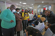 Deputy public protector Kholeka Gcaleka (in brown jacket) and Dr Steve Mankupane (in green) interact with the public at Barangwanath Hospital on Wednesday.