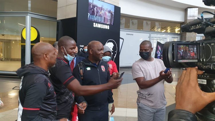 Al Ahly coach Pitso Mosimane greets fans as he and the team arrive at OR Tambo International Airport on Wednesday for their Caf Champions League match against Mamelodi Sundowns.