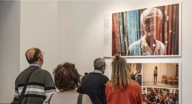 Exhibition attendees view the work of Hannah Reyes Morales - which was closed off to under-18s by the government