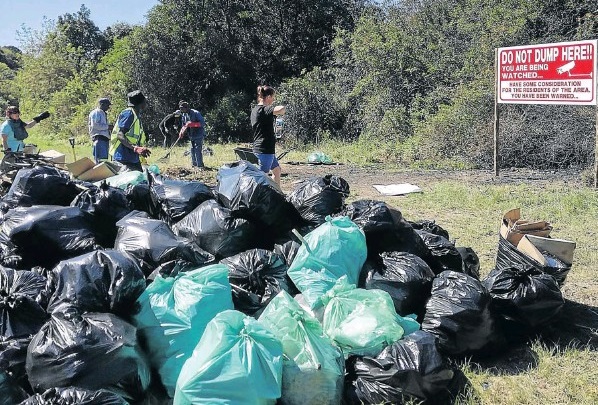 Beacon Bay residents clean up an illegal dumpsite on Beaconhurst Drive.