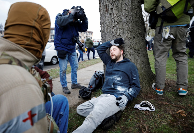 Medics tend to Casey Clements, who was hit with a chemical irritant round outside the Brooklyn Center Police Department, as protests continue days after former police officer Kim Potter fatally shot Daunte Wright, in Brooklyn Center, Minnesota, US April 14, 2021.