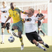 BRAVE TALK: Baby Bafana deputy captain Ramahlwe Mphahlele, left, fights for the ball with Germany's Lewis Holtby during their international  friendly match at the Husterhoehe Stadium in Germany recently.
       Photo: Getty Images