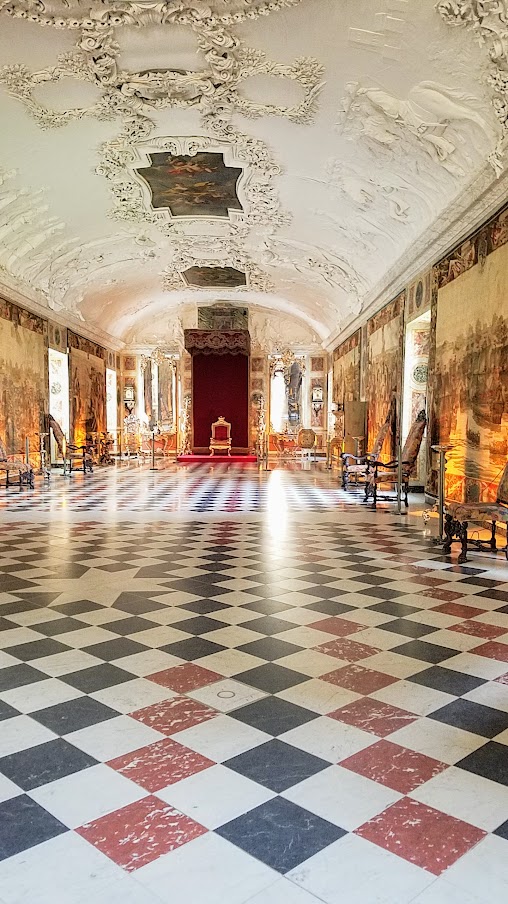 Visiting Rosenborg Castle in Copenhagen. On the third floor and is where you'll find the impressive Throne Room, also known as the Long Hall or Knights’ Hall. It was intended as a ballroom, and here you will find the coronation thrones for the king and queen and three life-size silver lions standing guard. On the other side of the room is displayed the throne for audience.