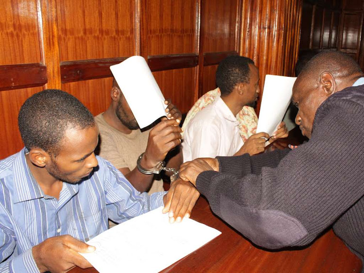 Suspects in the kidnapping of an Italian national Silvia Romano are removed chains at a Milimani court on January 23, 2019 where they were arraigned.